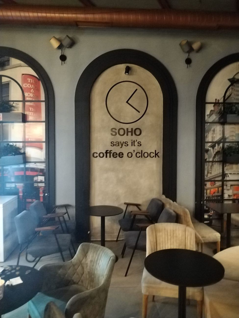 The lounge of SOHO BAR Tirana with armchairs and small tables